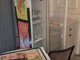 a small table and chairs in a room with a refrigerator