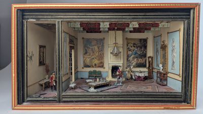 une maquette d'une pièce avec des tableaux accrochés aux murs