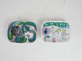 two plates with different designs on them on a white surface