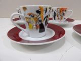 three cups and saucers sitting on a table