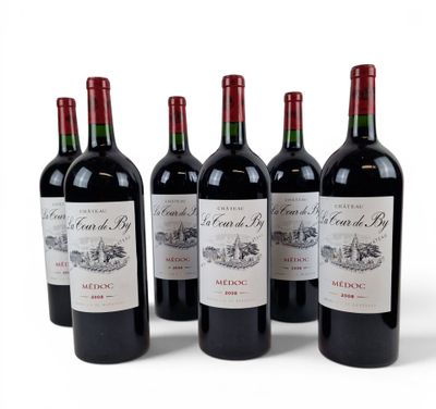four bottles of red wine are lined up on a white surface