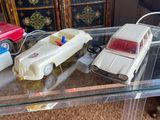 several toy cars are on a glass table in a living room