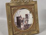 a gold picture frame with a picture of a man and a woman