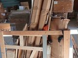 a cart full of boxes and a chair in a warehouse