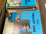 three books in a box on a table