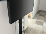 a flat screen tv on a stand in the corner of a room