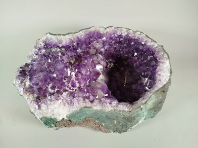 a close up of a piece of amethorate on a white surface