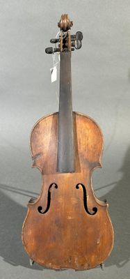 an old violin sitting on top of a table next to a wall