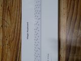 a piece of paper on a wooden table with a ruler on it