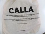a white bag with black writing on it sitting on a table