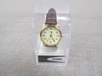 a watch that is in a clear box on a table