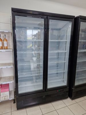 two refrigerators that are sitting in the middle of a room