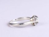 sterling silver ring with a diamond cut center stone and a thin band