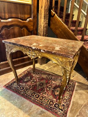 a table with a marble top on a rug in a room