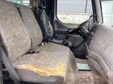a dirty seat in the back of a truck