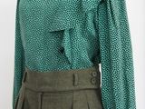 green blouse with ruffles and buttons on a mannequin mannequin mannequin mannequin mannequin mannequin mannequin mann