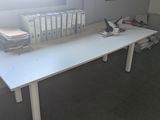 a white table with a bunch of books on top of it