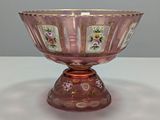 an image of a pink glass bowl sitting on top of a table