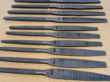 six pairs of black plastic knives sitting on top of a table