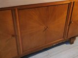 an image of a wooden cabinet with a mirror above it