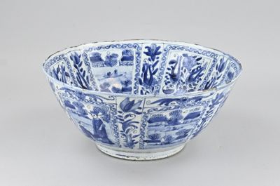 blue and white porcelain bowl with a pattern of flowers and trees