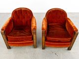 pair of orange velvet club chairs with wood legs