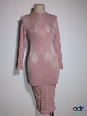 pink dress on a mannequin stand against a white wall