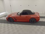 an image of an orange sports car in a garage
