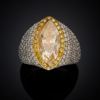 a yellow and white diamond ring with two rows of yellow and white diamonds