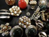 many different types of jewelry on a black surface