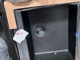 a black sink in the middle of a cardboard box