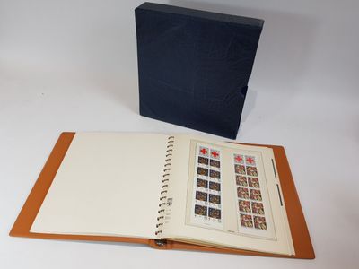 an open book with stamps on it sitting next to a blue box