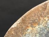 a close up of a metal object with a black background
