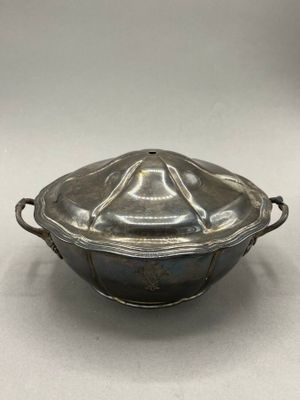 an antique silverplated casserole dish with a lid