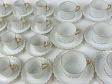 a lot of cups and saucers sitting on a table