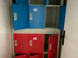 a red and blue locker in the corner of a room