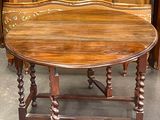 a wooden table with a bench on it in a room