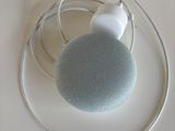a blue and white speaker on top of a wire