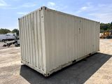 a white container sitting in the middle of a parking lot