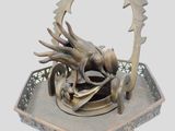 a metal sculpture of a dragon on a tray
