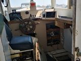 a view of the inside of a boat with a steering wheel