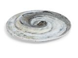 a white plate with a swirl on it on a white surface