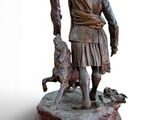 bronze statue of a man with a dog and a cat on a pedestal