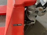 a red machine that is sitting on the ground