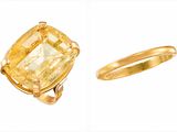 un gros plan d'une bague et d'une bague sertie d'une pierre jaune