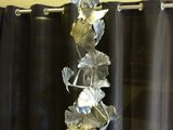 a glass sculpture of leaves on top of a table