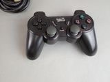 a video game controller sitting on a table next to a charger
