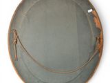 a round mirror with a rope hanging on the side of it