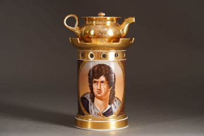 a gold tea pot with a picture of a man on it
