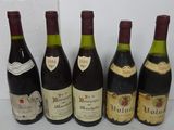 six bottles of wine are lined up on a table